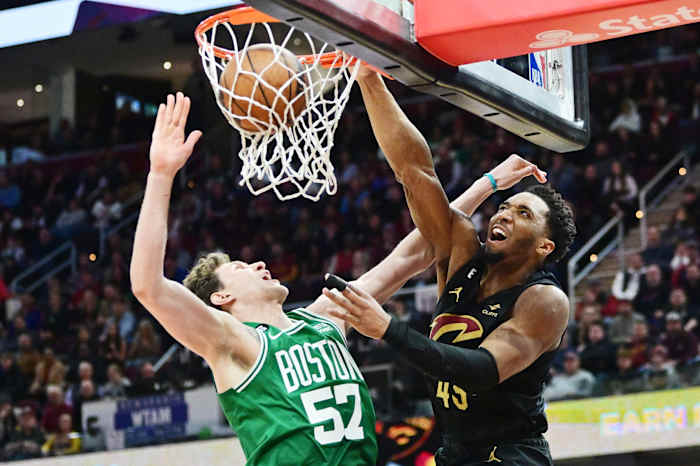 Mar 6, 2023; Cleveland, Ohio, USA; Cleveland Cavaliers guard Donovan Mitchell (45) dunks over Boston Celtics center Mike Muscala (57) during overtime at Rocket Mortgage FieldHouse. Mandatory Credit: Ken Blaze-USA TODAY Sports